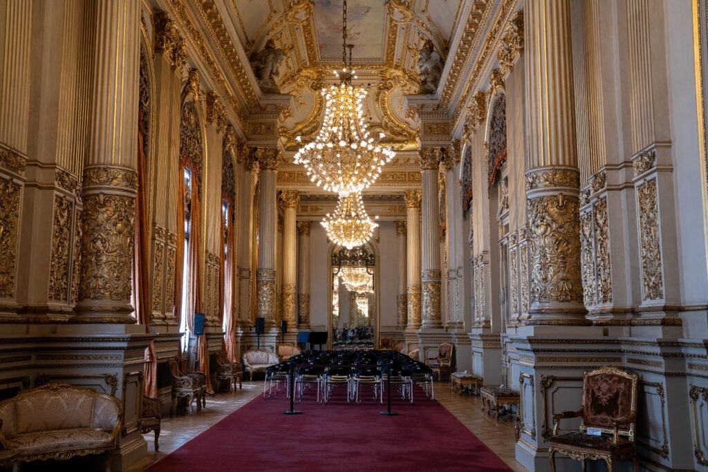 Grand interior of Teatro Colón featuring elegant chandeliers and intricate gold detailing in Buenos Aires.